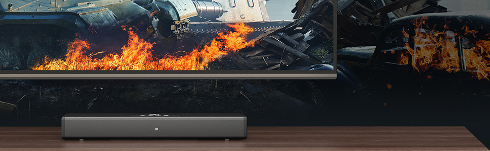 Sound bar in front of television, sound bar features Dolby Atmos
